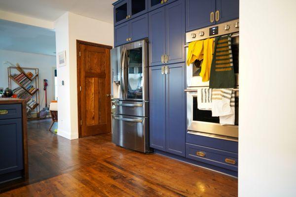 The kitchen remodel, featuring the cabinets, fridge and double-oven.