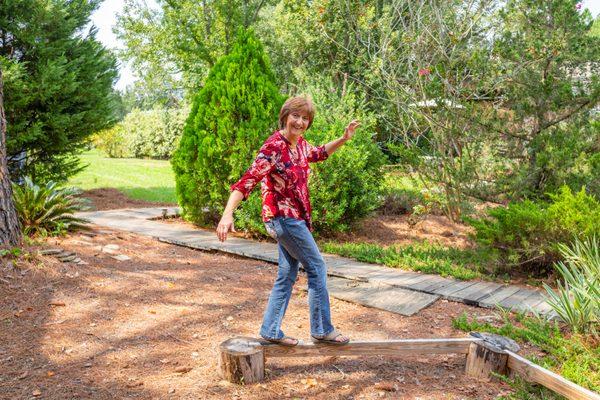 Take a walk on the "balance beam" under the elf tree!