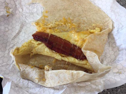 Dissapointment Burrito! 1 slice of bacon, skimpy on the eggs and a pinch of cheese