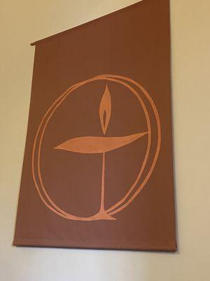 Large banner of the Unitarian Universalist symbol; a chalice and flame