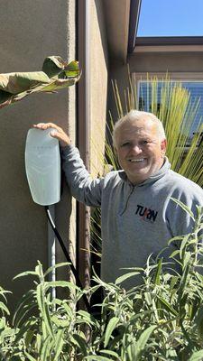 Steve next to the Tesla universal charger he installed at our home.