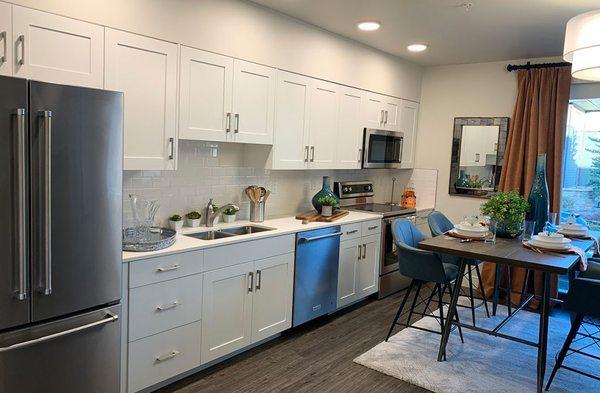 View of kitchen appliances and table of nexus on 9th apartment interior