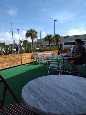 The outside patio has astro turf and a mix of wicker or metal chairs. Very cute.