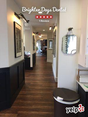 Main hallway inside Brighter Days Dental. Their decor is wood floors with industrial lighting, vintage decor in each room.