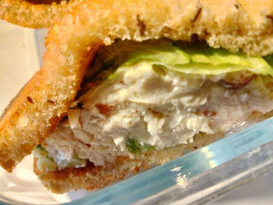 Chicken with nutty mayo spread and lettuce on toasted rye