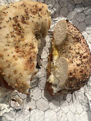 Bacon, egg and pepper Jack cheese on everything bagel with hot sauce and ketchup.