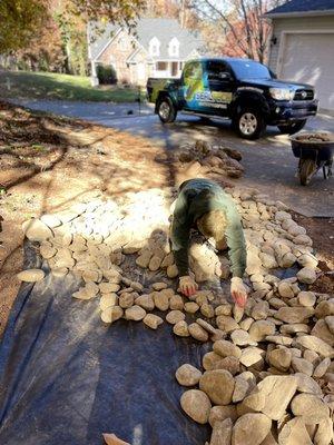 Water mitigation, river rock installation.