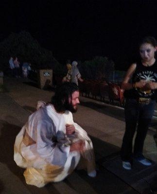 Jesus getting down to kid's levels.