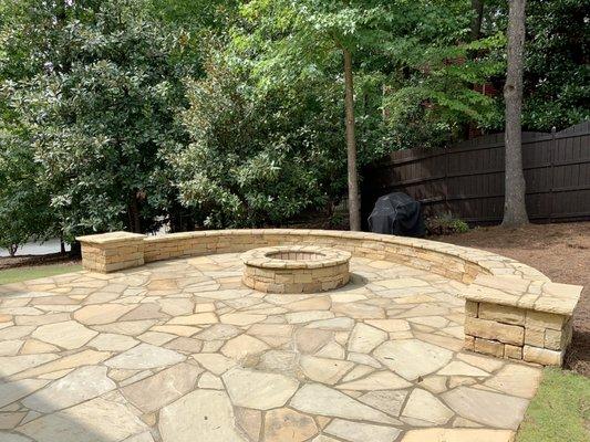 Irregular Flagstone patio, stacked stone fire pit, columns, and bench