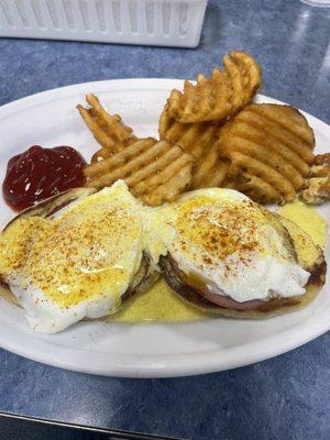 Cold eggs Benedict with broken hollandaise and soggy waffle fries saturated with grease.