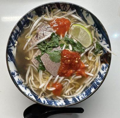 This is pho pho's beef pho to go that I took home and put in my own bowl and added some sambal oelek.