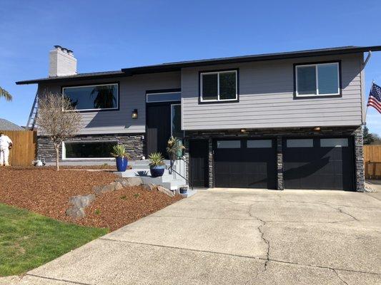 Beautiful two story house, with a sleek black and grey modern spray paint job