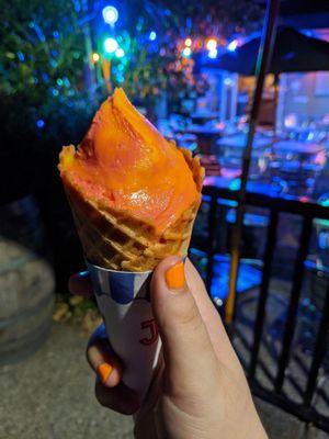 Sorbet in a waffle cone (in the process of being eaten)