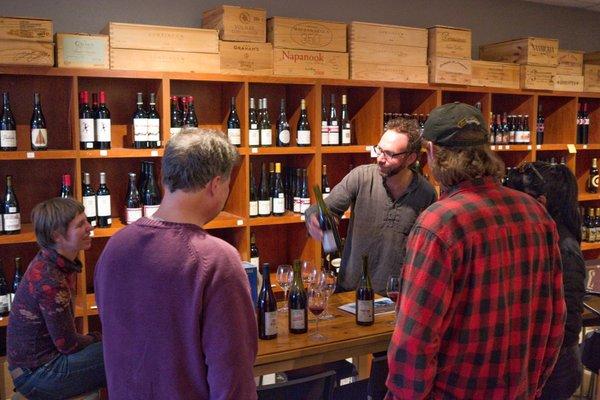 Beaujolais natural wine producer Romain des Grottes showing his wines to customers.