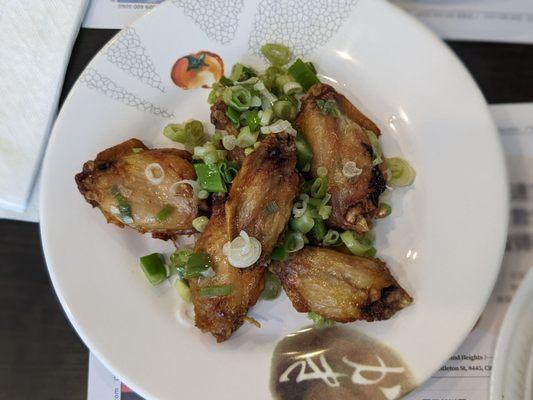 Fried chicken wings with scallions and jalapeno