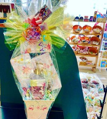 A beautiful gift  basket with chocolate and soap, and other sweets.