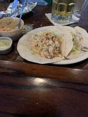 Fish tacos served with a creamy salsa and verde sauce. Very good!