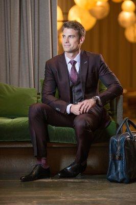 Custom Burgundy three-piece suit with plaid vest and contrasting lapel buttonhole - Balani Custom Clothiers