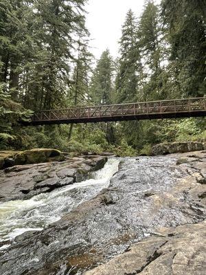 View from the rocks, simple path leading down next to the right side of the bridge.