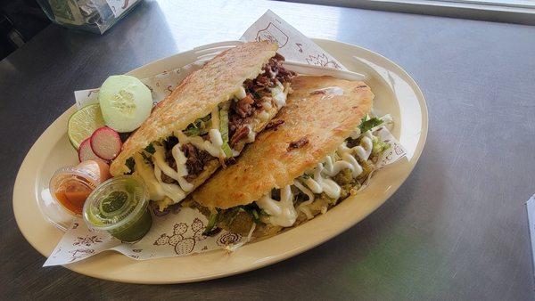 Hand-made corn gorditas stuffed with refried beans, cheese, shredded beef, sour cream, onion, cilantro and lettuce.