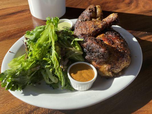 Half chicken portion, with Aji Verde and Aji Rocoto sauces.