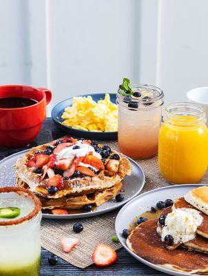 Jack's Colossal Pancake Stack loaded with blueberries + Mama's classic waffle with fresh strawberries & blueberries.