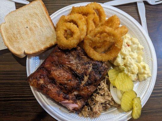 Pork and ribs with onion rings and potato salad