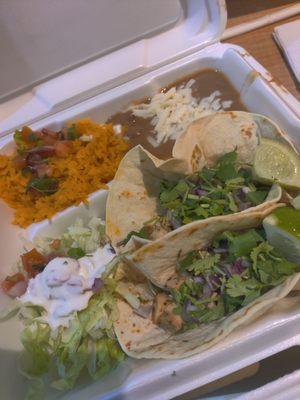 Taco plate (chicken, flour tortilla), served with rice and beans.