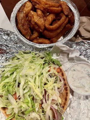 Classic gyro with sauce on the side and deliciously greasy onion rings.