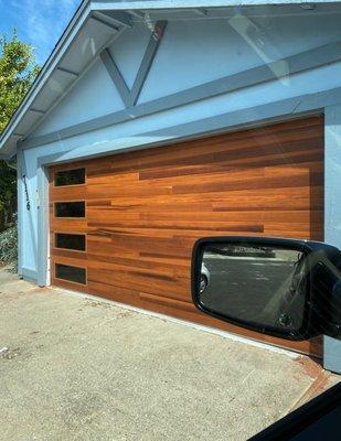 Installed a Plank Collection garage door in the cedar woodtone accent color and tinted glass.