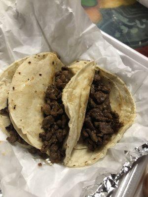 Carne asada tacos. They come with doubled corn tortillas.