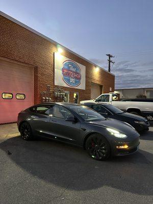 Tesla Tire rotation, top off fluids, check wheel balance.