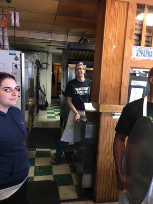 A busy staff with a real New York pizza oven!