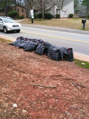 Bags  of leaves left since Dec. 8th. Is it Jan. 27th . Neighbor on the left.