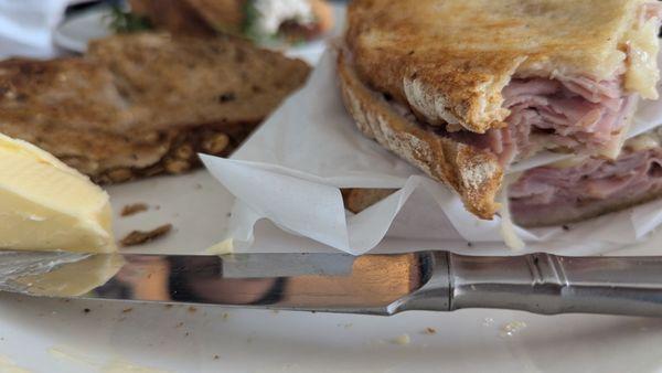 A delicious croque monsieur alongside amazingly French butter and multi grain bread made in house!