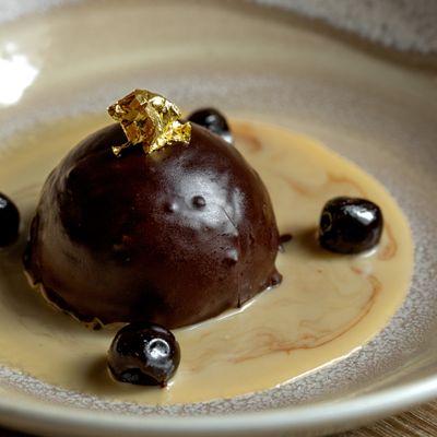 CIOCCOLATO FONDENTE | chocolate mousse bomb, almond cookie base, bourbon crème anglaise, Amarena cherry, gold leaf