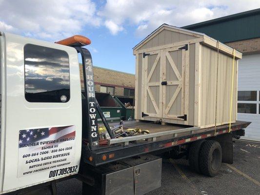 Small building being hauled to its new home. 609-364-7006 for fast free price Qoute