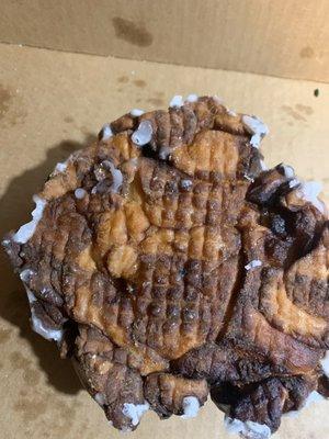 Burnt to crap Apple Fritter served at my work function.  How does this pass any sort of inspection. Looks like a dead turtle!