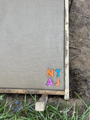 Their creative solution to initials in the quick drying concrete, since the kids were still at school.