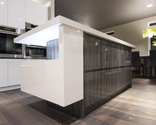 Custom designed island with high gloss lacquer cabinets and quartz countertop.