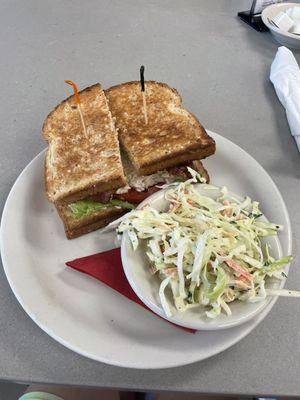 Chunky chicken salad sandwich with bacon, and cole slaw side