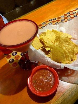 Small strawberry margarita with chips and salsa