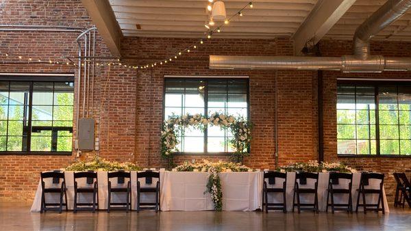 Head table in front of exposed brick