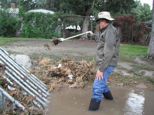 Kelly uses the Grappler to clean out a nearby drainage ditch from debris a reason rainstorm.