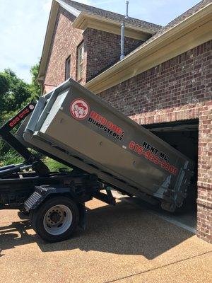 Sliding a 10yd dumpster into a garage!