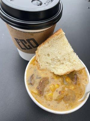 Cup of Cajun smoked sausage corn chowder and fresh baked bread