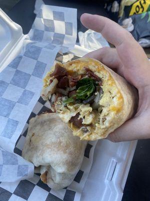 Sunrise breakfast burrito with bacon, cheddar, tomato, mushrooms, and spinach