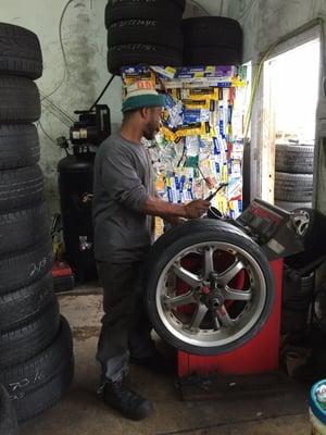 Technician balancing a wheel.