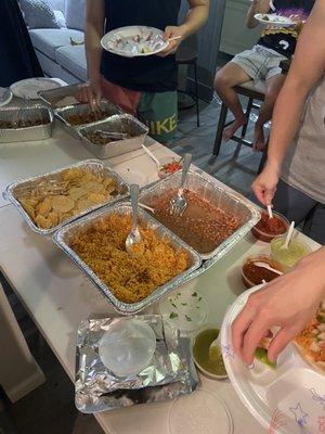 Catering for 8 people.  3 meats: Steak asada, chicken, carnitas.  Rice  Beans Chips Salsas