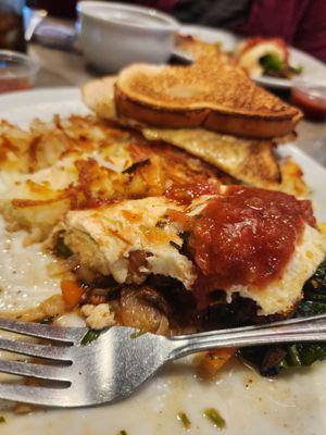 Half eaten egg white omlette with hash browns and white toast.  Oh, and a fork.